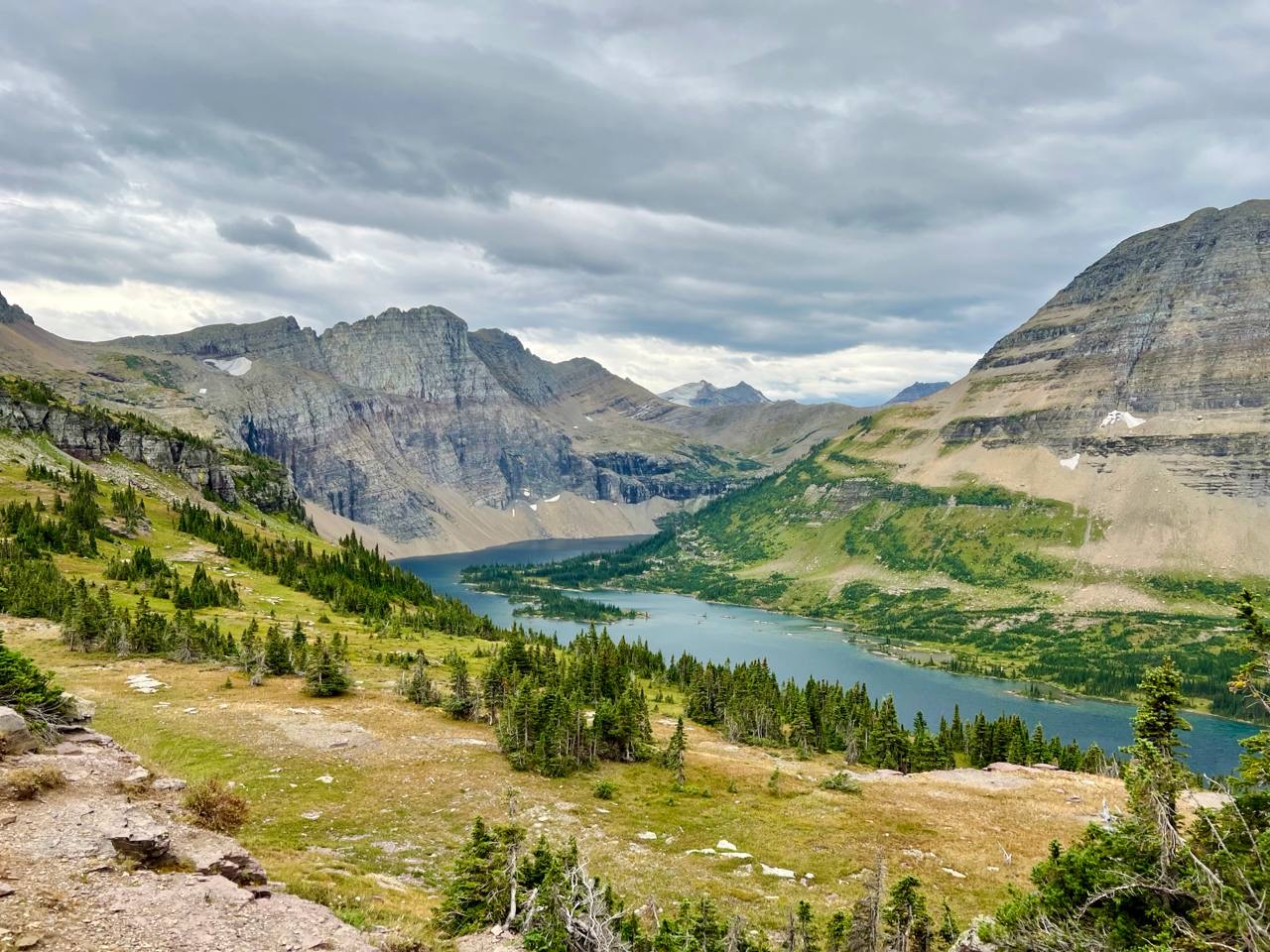 Mountain lake below dramatic cloud cover